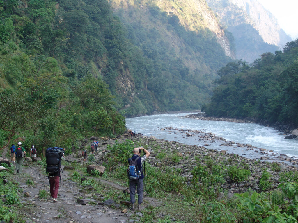 Travellers passing by the Buri Gandaki River in the Manaslu Region